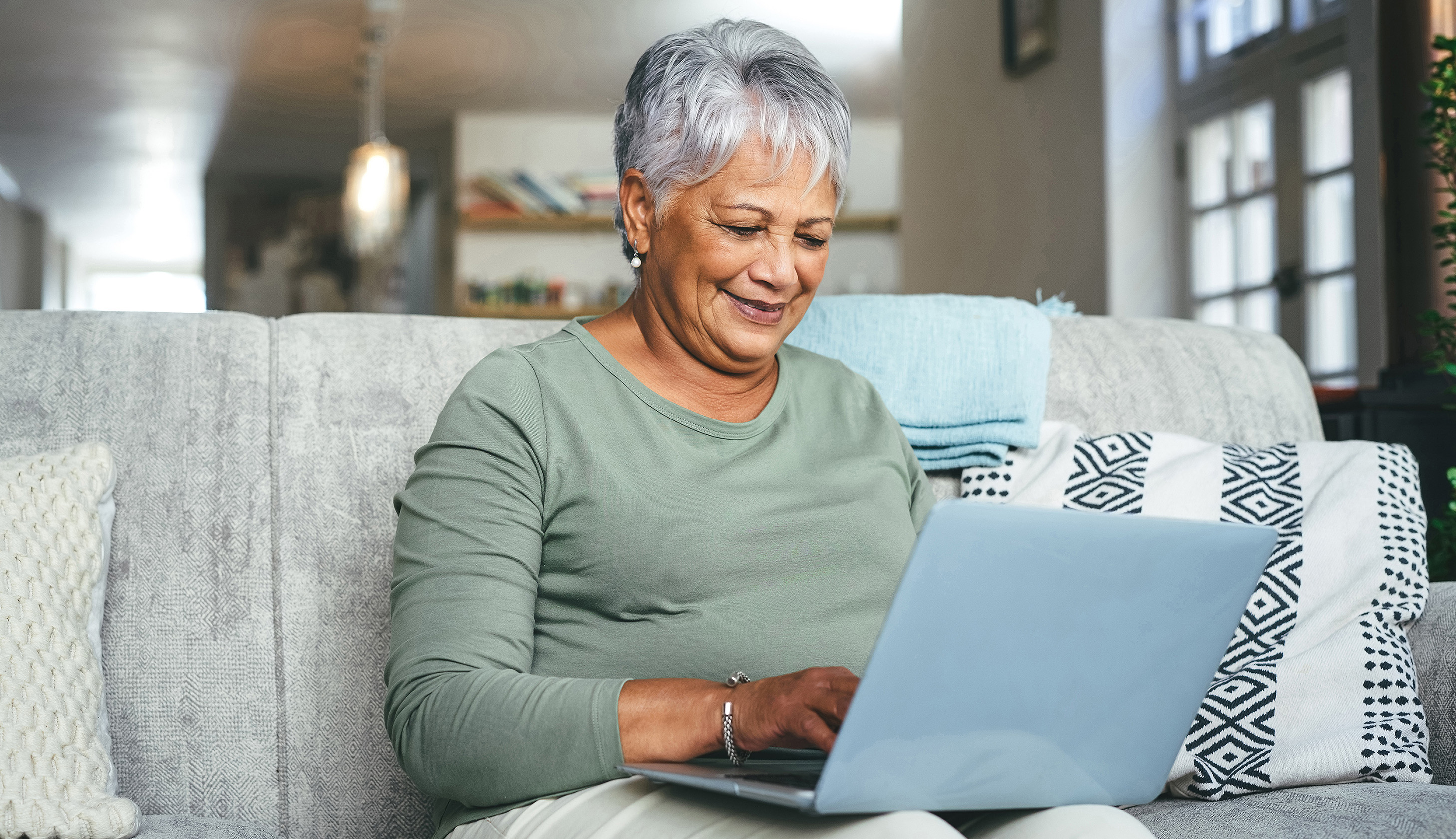 Elderly woman using laptop computer