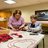 Barb from Barb's Love Wreaths teaching residents how to create Rose Wreaths for their Suite Doors  