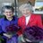 Two ladies holding bouquets of flowers.